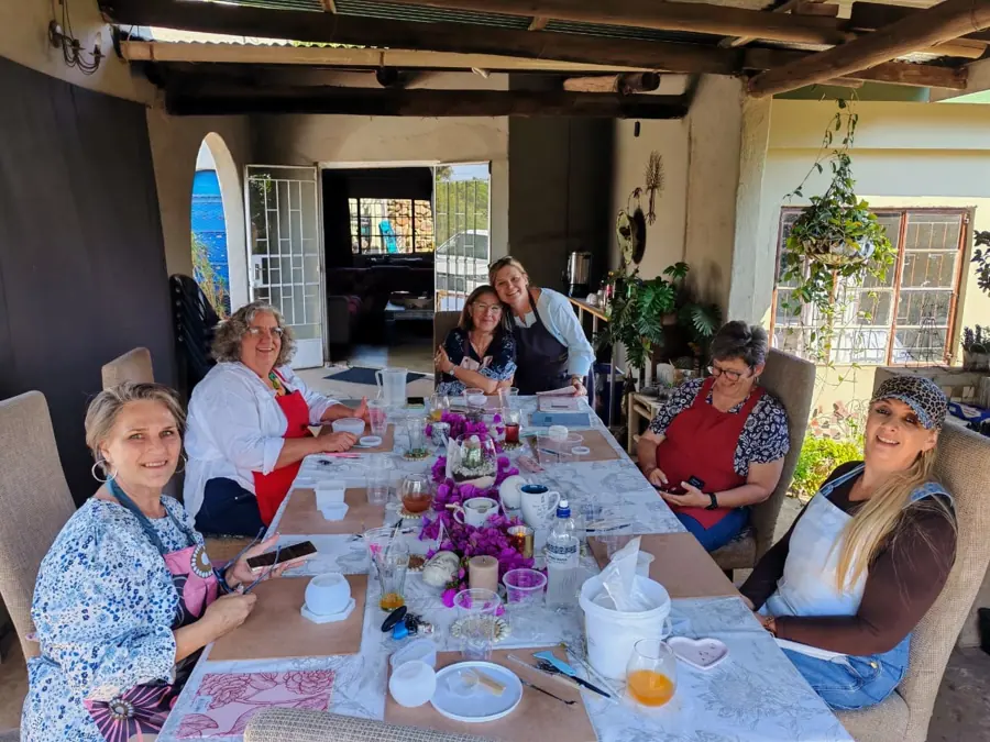 Guests creating together around a workshop table