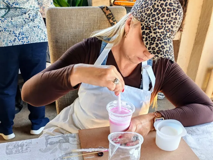 A guest mixing resin colour at a workshop